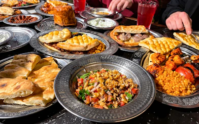 Turkish dishes on a table during a food night in Istanbul, featuring kebabs, bread, and salads.