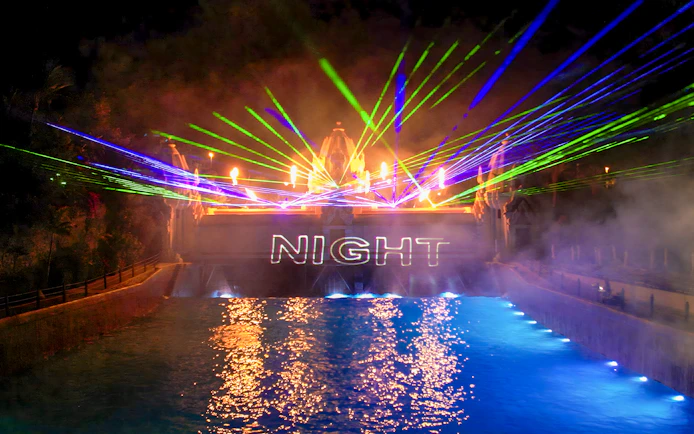 Laser show over water at Siam Park at night.