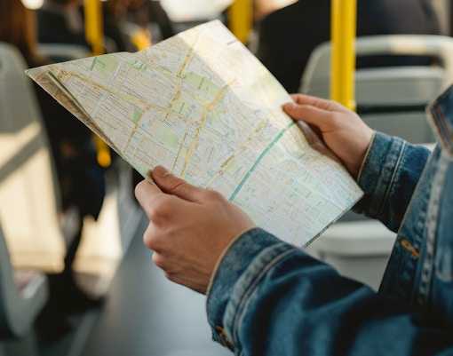 Woman using a map on a hop-on hop-off bus in Valencia, Spain.
