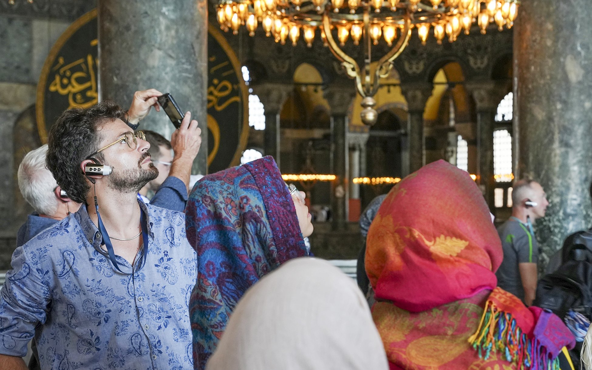 Visitors using audio guides inside Hagia Sophia, Istanbul.