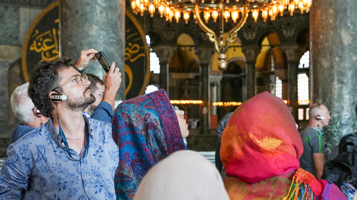 Visitors using audio guides inside Hagia Sophia, Istanbul.