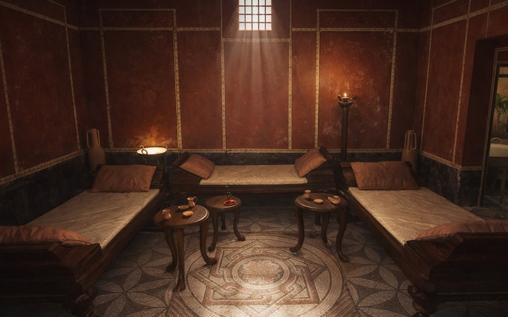 Ancient Roman-style room with mosaic floor and wooden couches, part of Setas de Sevilla tour.