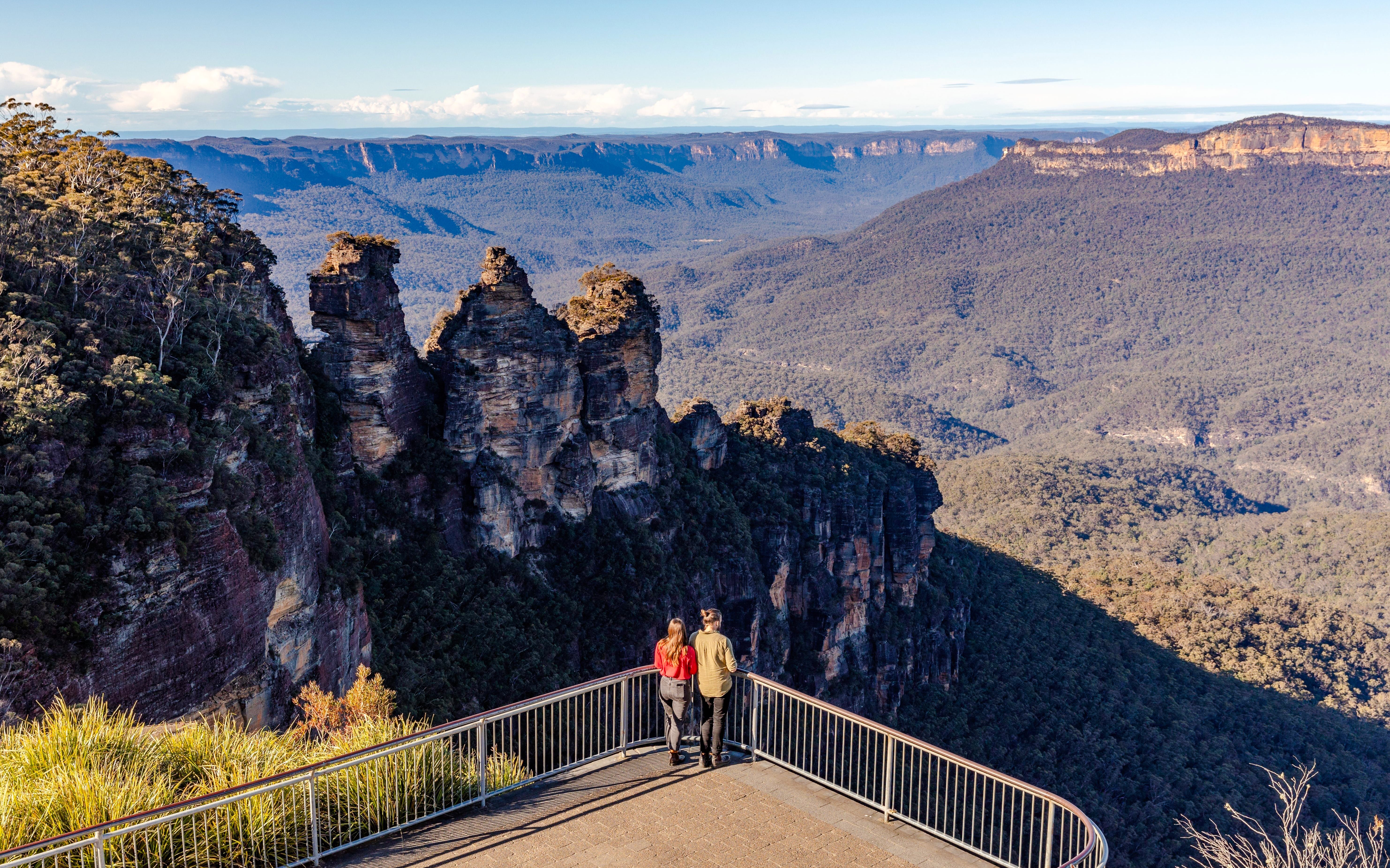 Couple viewing the Three Sisters rock formation in Blue Mountains, Australia.