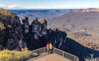 Couple viewing the Three Sisters rock formation in Blue Mountains, Australia.