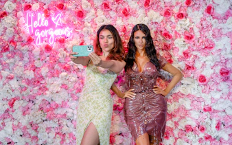 Woman taking selfie with wax figure at Madame Tussauds, New York.