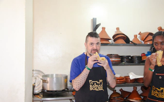 Participants enjoying Moroccan bread during cooking class in Agadir kitchen.
