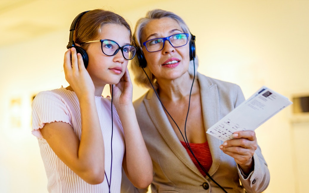 Visitors using audio guides at the National Coach Museum tour.