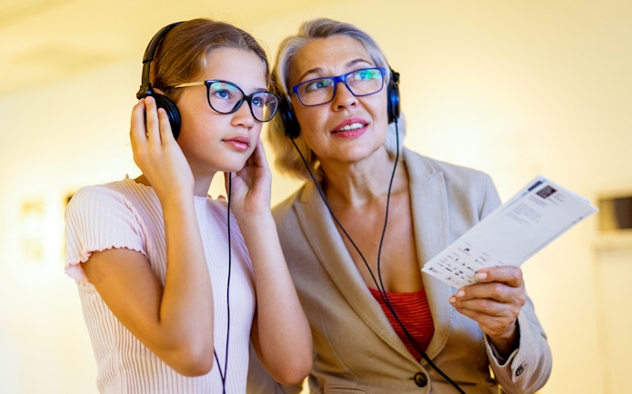 Visitors using audio guides at the National Coach Museum tour.