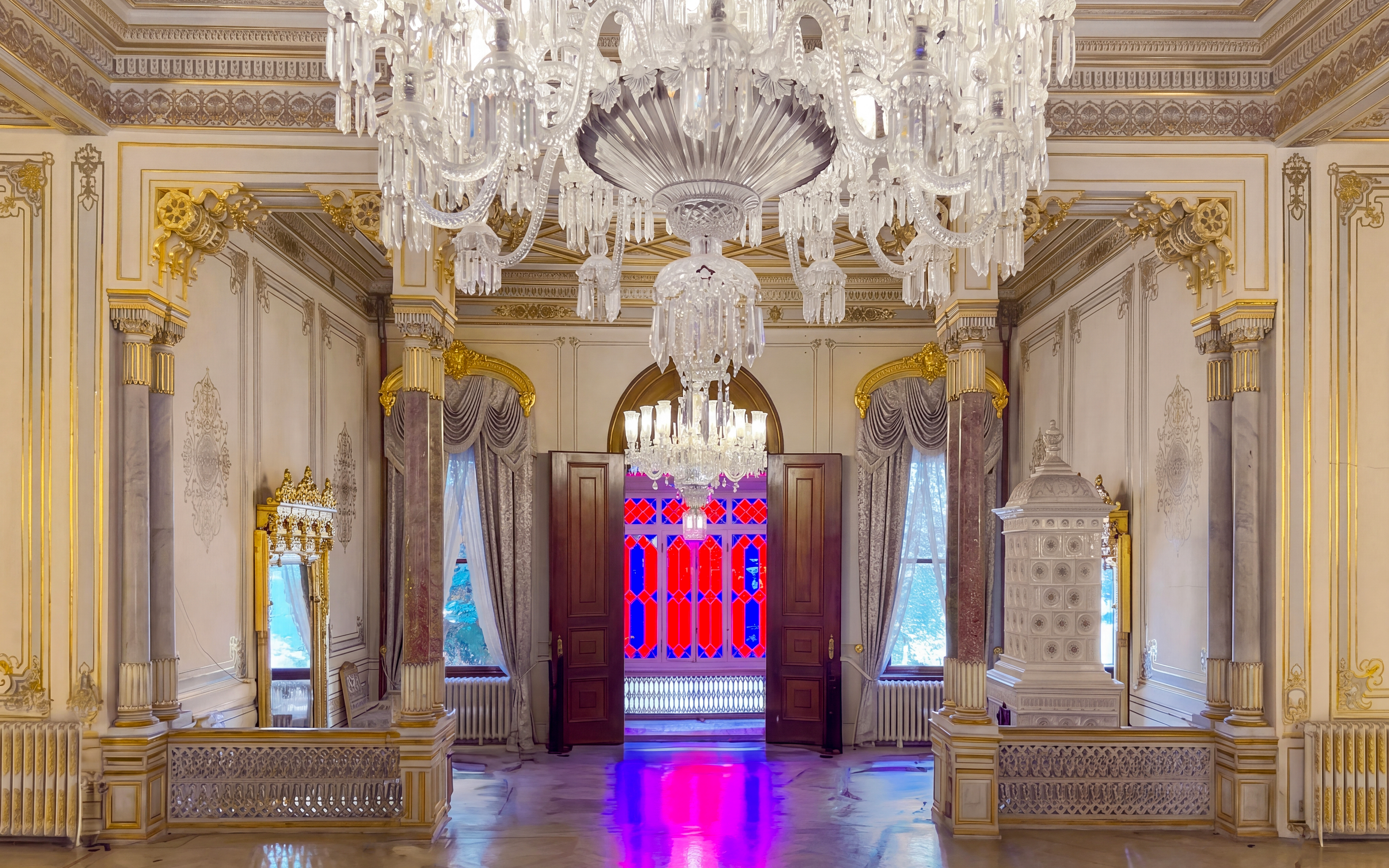 Yildiz Palace ornate interior with chandeliers and stained glass windows.