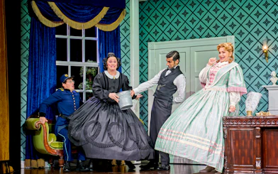 Actors in period costumes performing a comedic scene in "Oh Mary!" stage play.