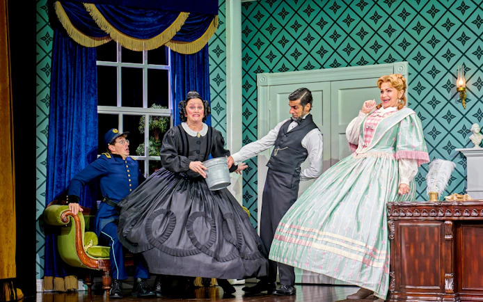 Actors in period costumes performing a comedic scene in "Oh Mary!" stage play.