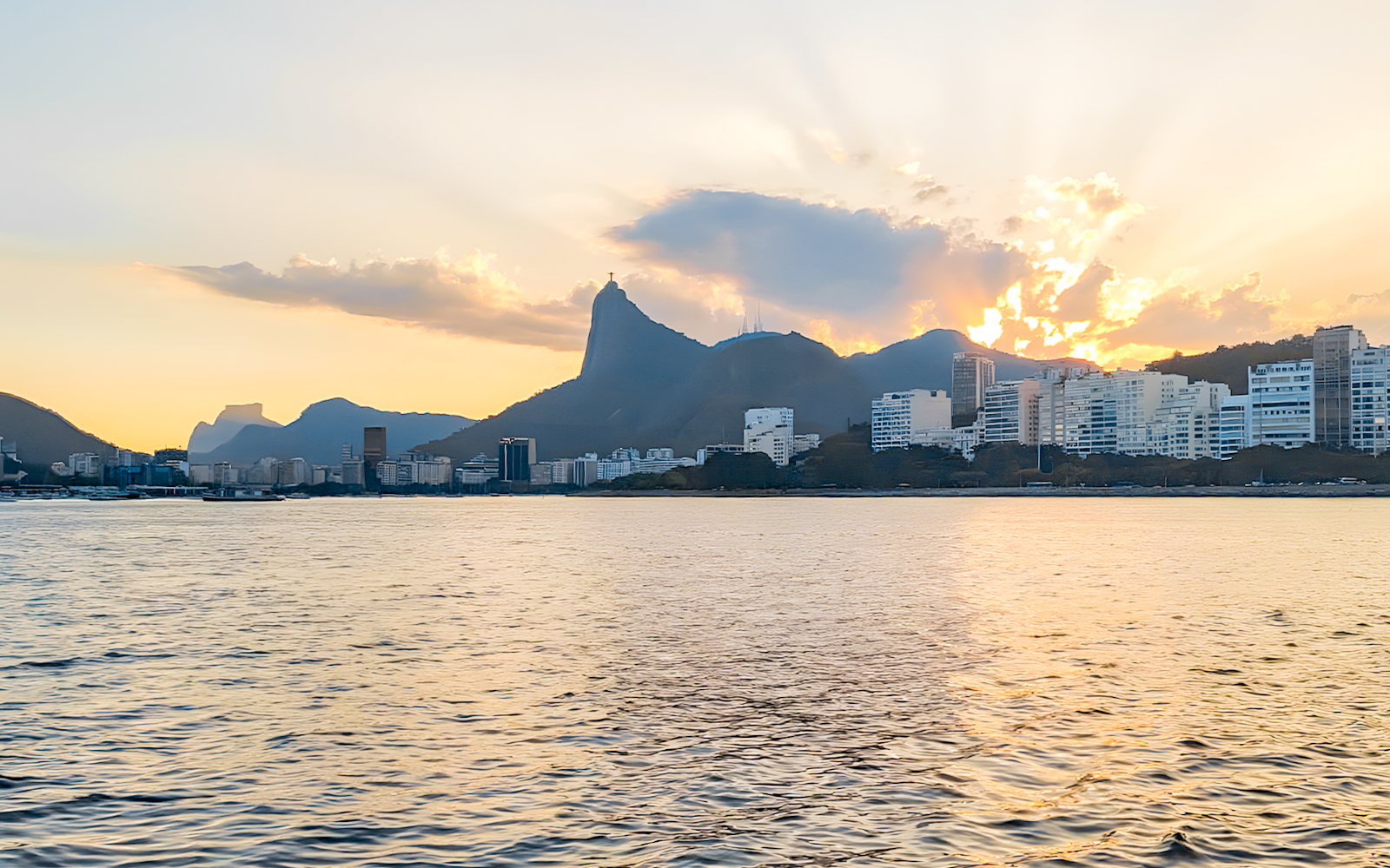 Rio de Janeiro skyline and Christ the Redeemer from sailboat at sunset.