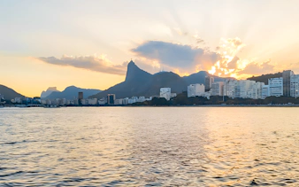 Rio de Janeiro skyline and Christ the Redeemer from sailboat at sunset.