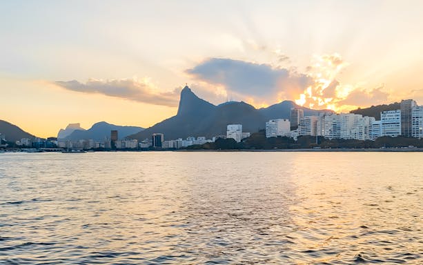 Rio de Janeiro skyline and Christ the Redeemer from sailboat at sunset.