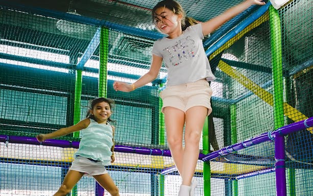 Children playing on trampolines at Jungle Gym, KL East Mall, Malaysia.