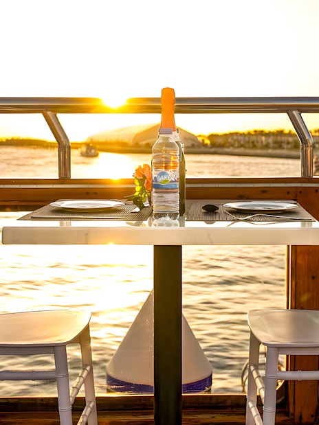 Dinner table on a dhow cruise at sunset, Dubai Marina.
