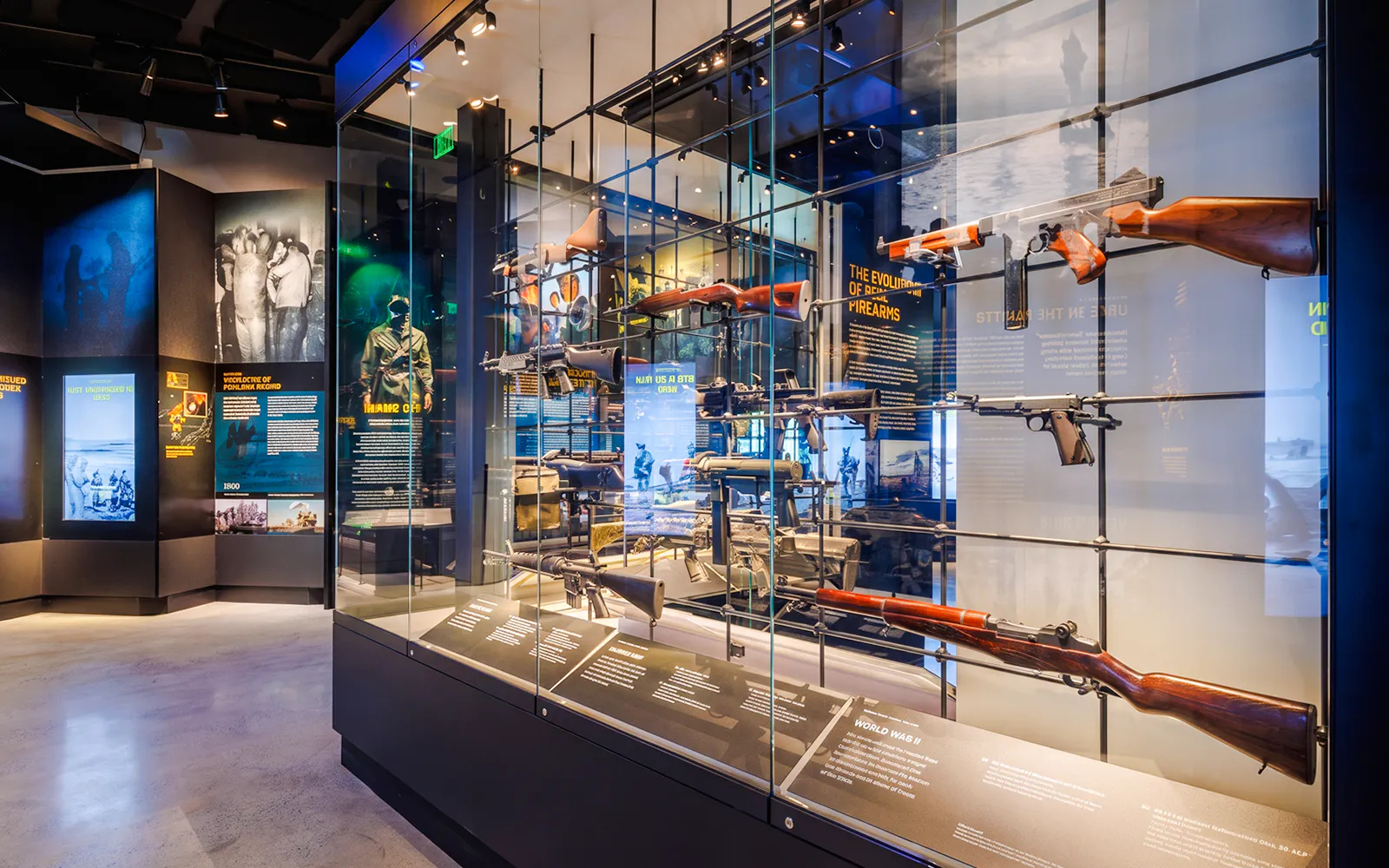 Firearms exhibit at the National Navy SEAL Museum, San Diego, showcasing historical weapons and informational displays.