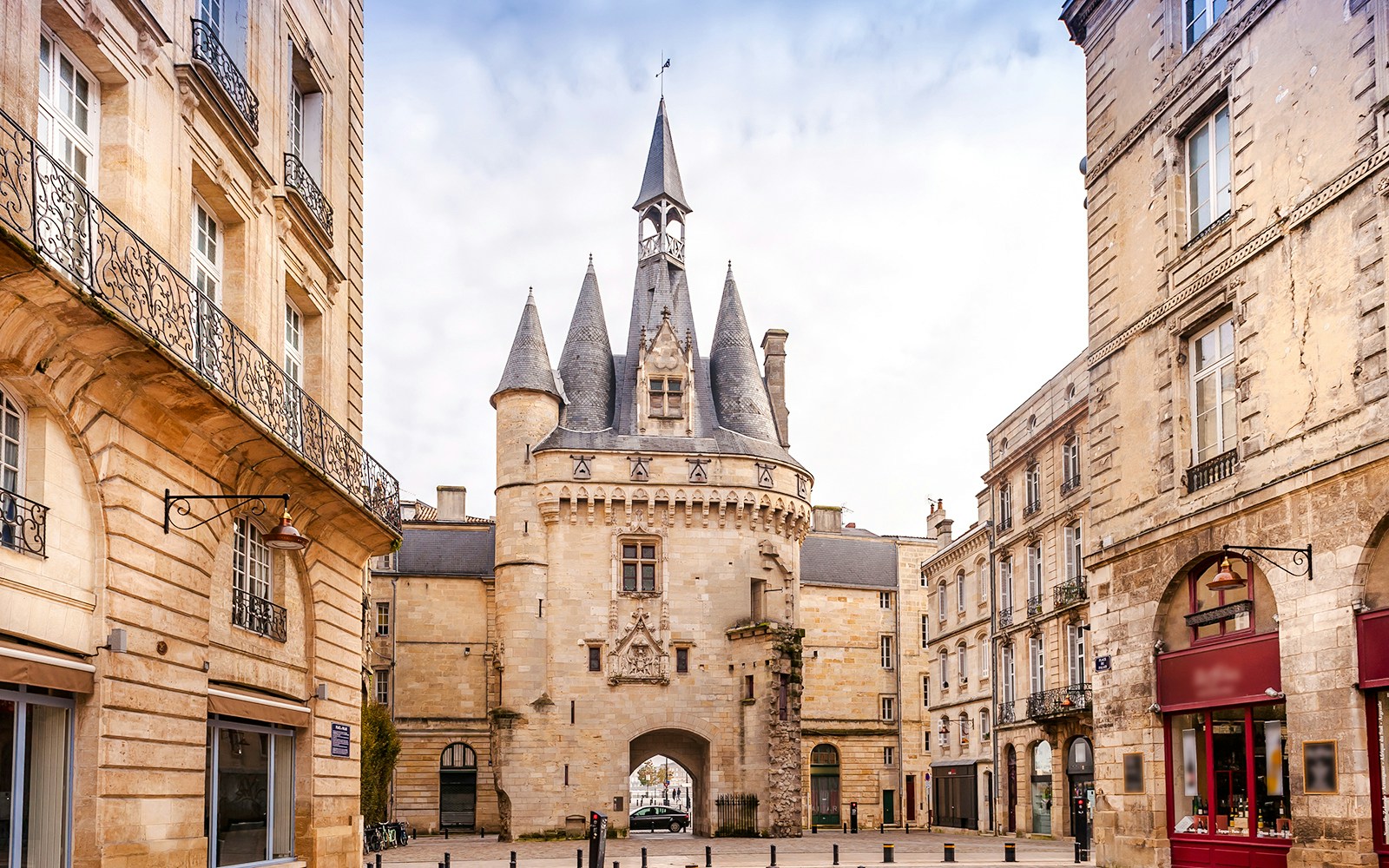 Porte Cailhau in Bordeaux, a historic city gate with Gothic architecture, surrounded by old buildings.