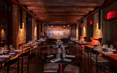Flamenco De Leones Show venue with tables set for dining, stage in background.