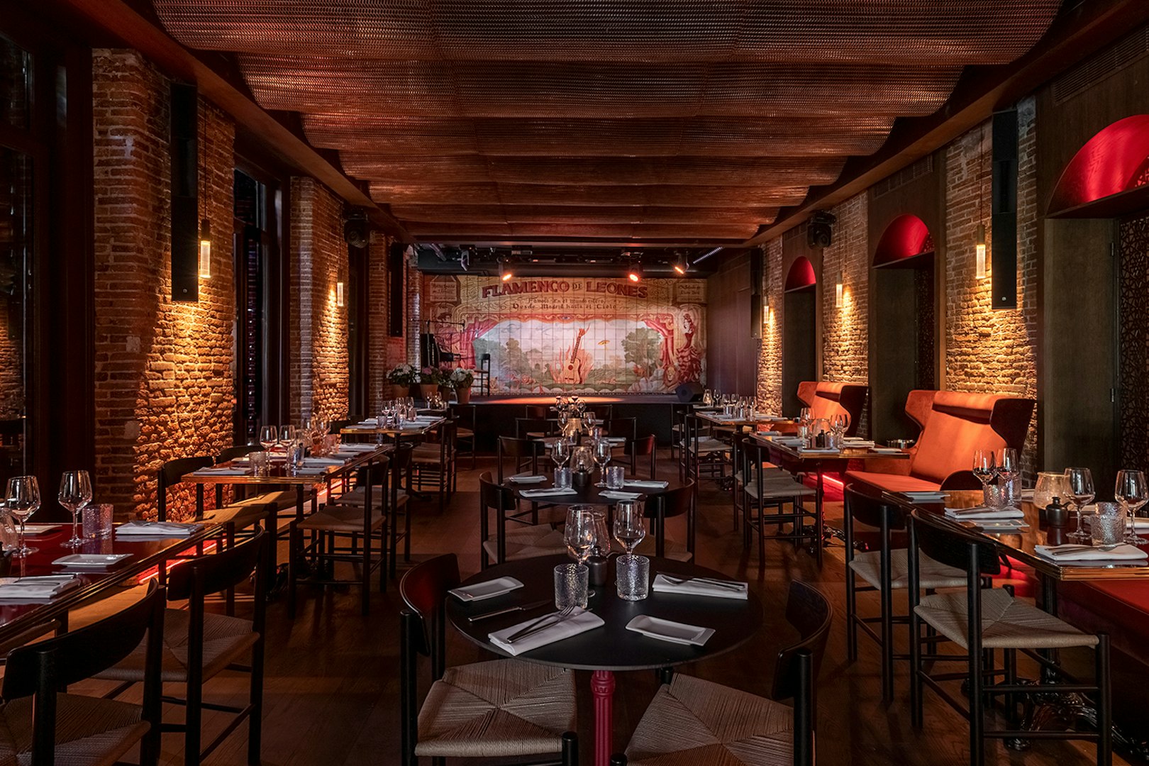 Flamenco De Leones Show venue with tables set for dining, stage in background.