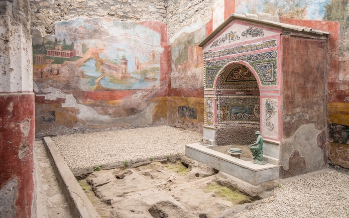 Ancient frescoes and mosaic shrine in the interiors of Pompeii ruins, Italy.
