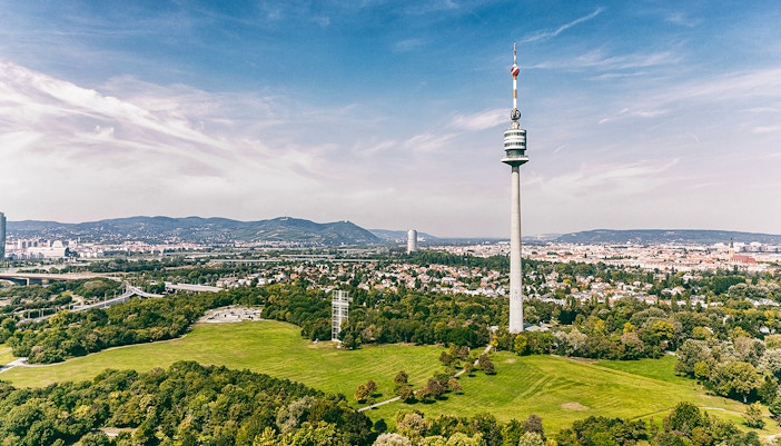 View of Danube Tower in Vienna, Austria, overlooking the cityscape and lush greenery.