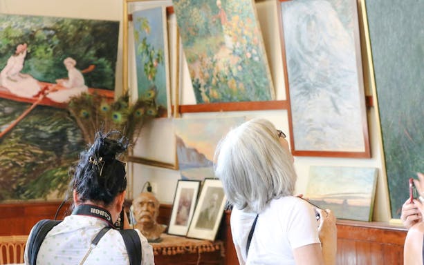 Visitors viewing paintings at Claude Monet’s home and gardens in Giverny.