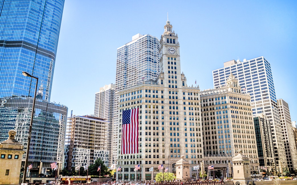 Wrigley Building with American flag in downtown Chicago.