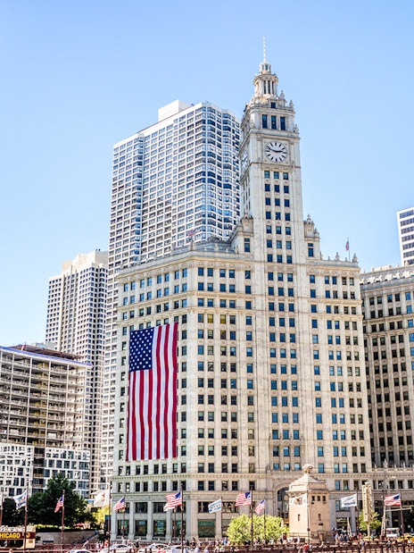Wrigley Building with American flag in downtown Chicago.
