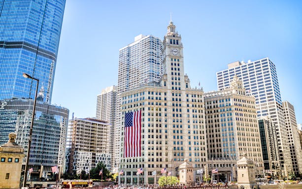 Wrigley Building with American flag in downtown Chicago.