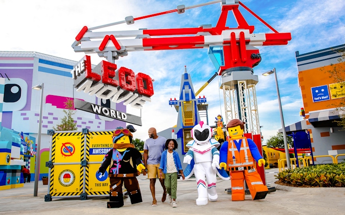 Family walking with LEGO characters at The LEGO Movie World, LEGOLAND® California.