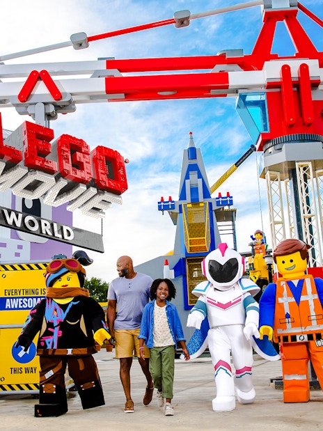 Family walking with LEGO characters at The LEGO Movie World, LEGOLAND® California.