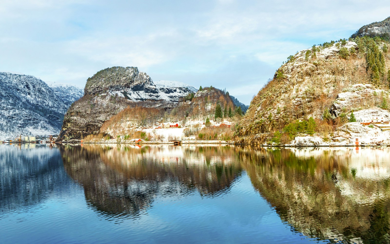 Osterfjord Norway winter reflection with snow-covered mountains and calm water.