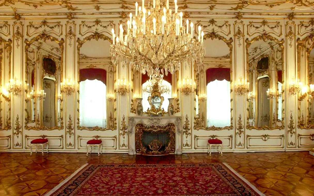 Imperial apartments with ornate chandeliers and mirrors in Sisi Museum.