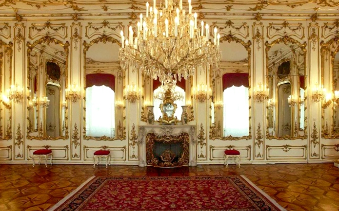 Imperial apartments with ornate chandeliers and mirrors in Sisi Museum.