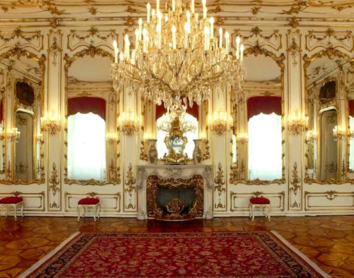 Imperial apartments with ornate chandeliers and mirrors in Sisi Museum.