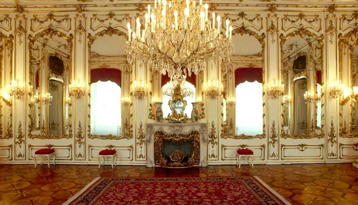 Imperial apartments with ornate chandeliers and mirrors in Sisi Museum.