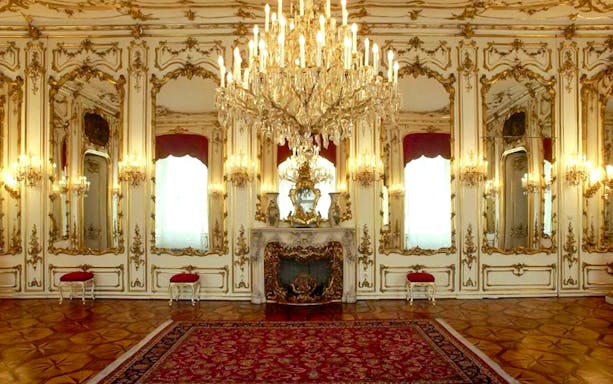 Imperial apartments with ornate chandeliers and mirrors in Sisi Museum.