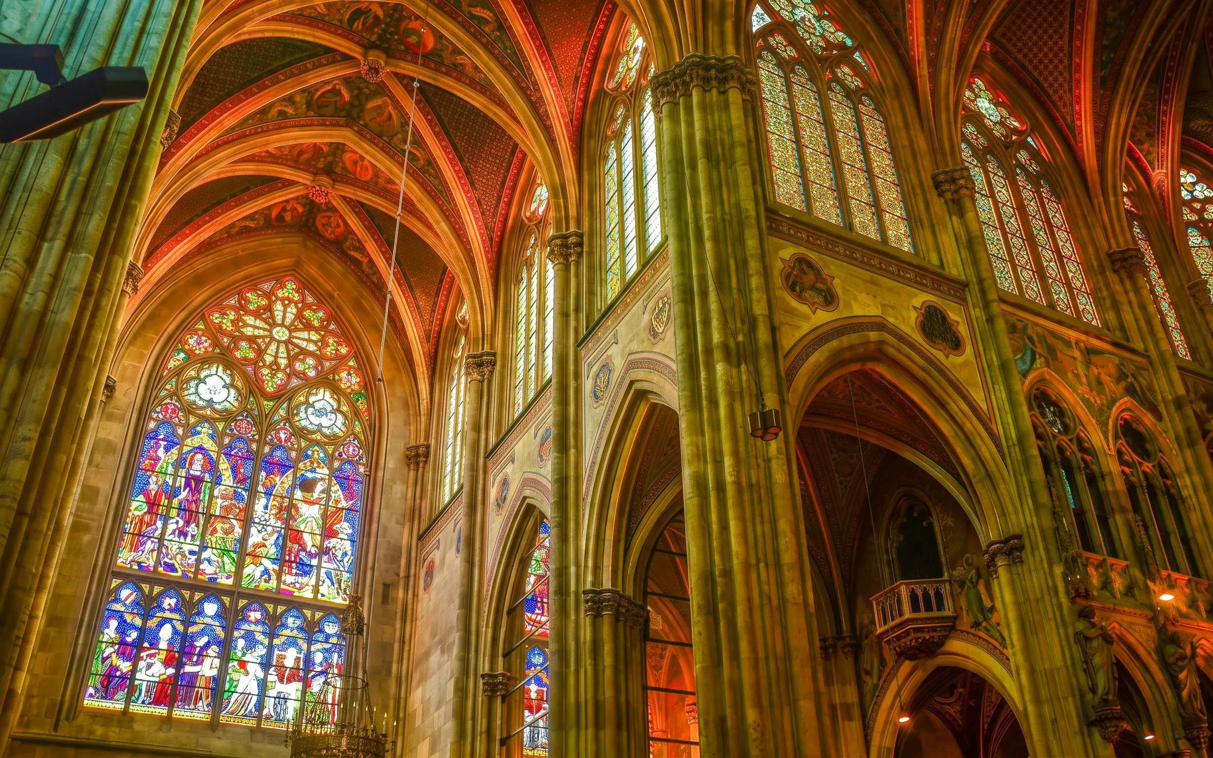 Stained glass windows and vaulted ceilings inside Notre-Dame Cathedral, Paris.