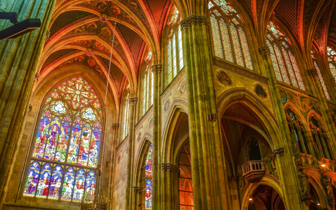Stained glass windows and vaulted ceilings inside Notre-Dame Cathedral, Paris.