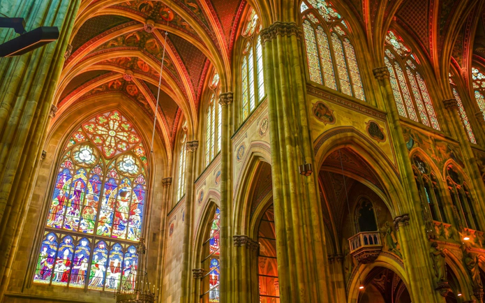 Stained glass windows and vaulted ceilings inside Notre-Dame Cathedral, Paris.