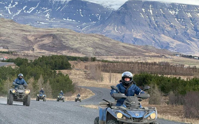 ATVs on mountain trail with panoramic views of Reykjavik peaks and lake, Twin Peaks Tour, Iceland.