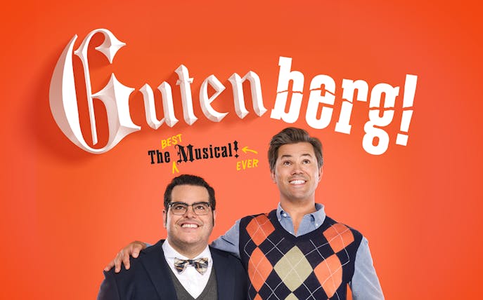 Gutenberg! The Musical! promotional image with two smiling men against an orange background.