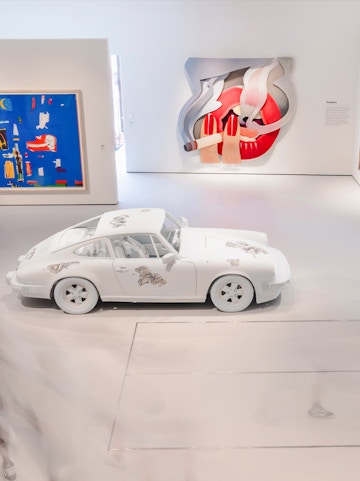 White car with artistic designs in Moco Museum London gallery.