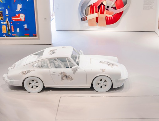 White car with artistic designs in Moco Museum London gallery.