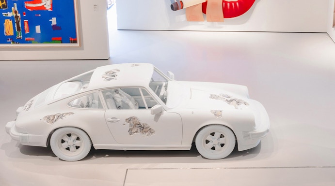 White car with artistic designs in Moco Museum London gallery.