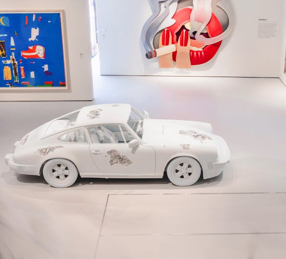 White car with artistic designs in Moco Museum London gallery.