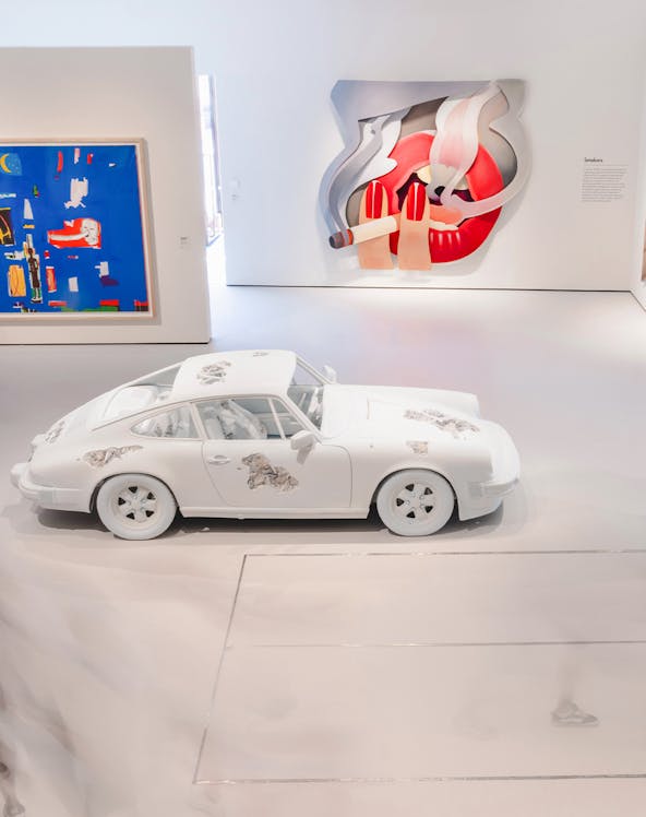 White car with artistic designs in Moco Museum London gallery.