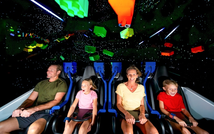 Family enjoying the Galacticoaster ride at LEGOLAND California Resort.