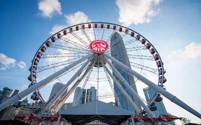Hong Kong Observation Wheel with city skyscrapers in the background.